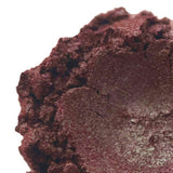 Close-up of a vibrant, reddish-brown handmade powder product from Nurture Handmade.