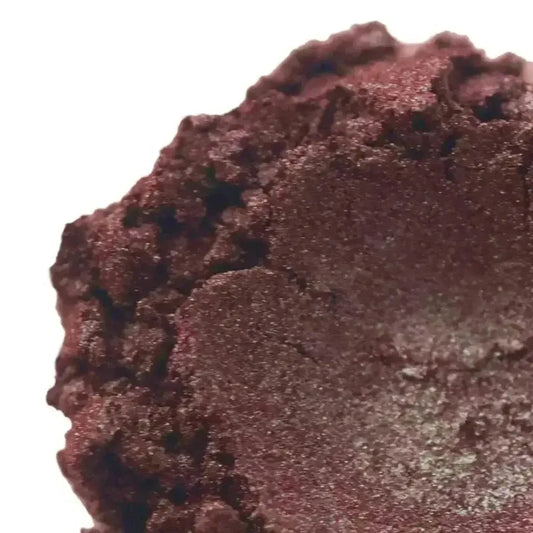 Close-up of Magic Mushroom Brown/Red Mica showing shimmering red and silver hues for vibrant cosmetics.