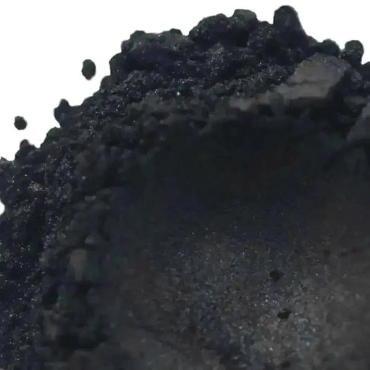 Close-up of Nocturnal Black Mica powder, a captivating black mineral perfect for dramatic cosmetic and artistic creations.