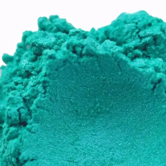Close-up of Synergy Turquoise Mica powder showcasing its vibrant blue-green hue for creative projects.
