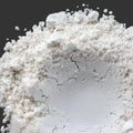 Kaolin natural clay mound of fine white powder with gritty texture and clumps