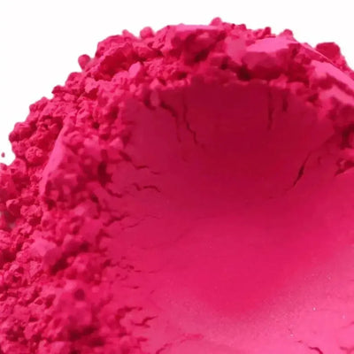 Mound of hot pink magenta mica powder on white