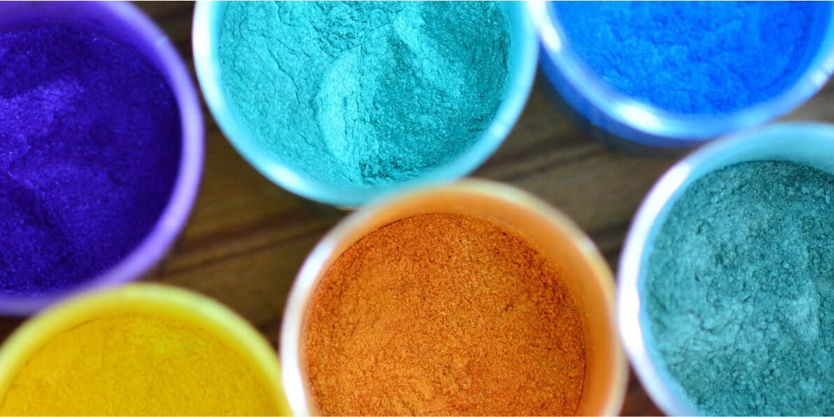 Colorful bowls of powdered pigments in vibrant hues, perfect for art and crafting projects.
