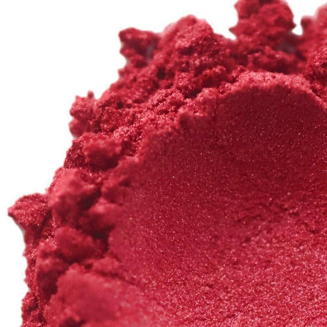 Vibrant red powder close-up, showcasing texture, perfect for cosmetics and Nurture Handmade beauty products.