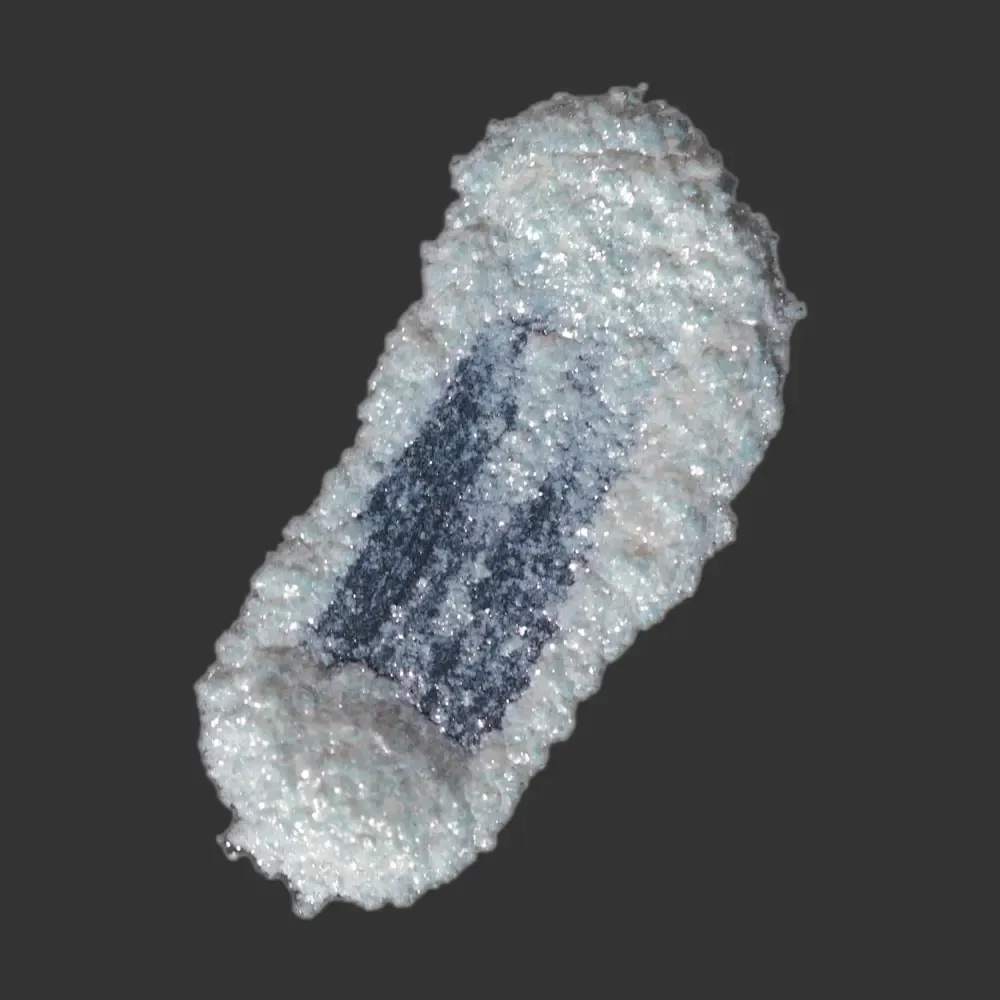 Mystic Red White Mica Glitter: textured elongated specimen with white crystalline exterior and dark blue core