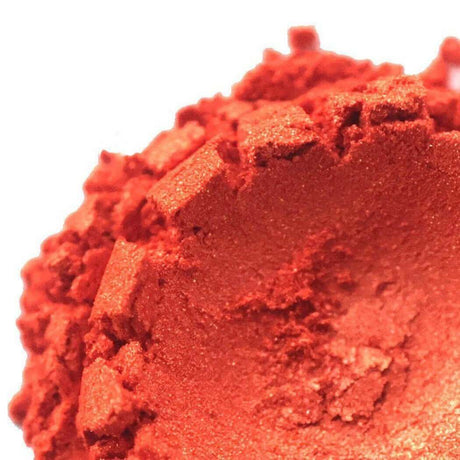 Close-up of shattered bright red-orange eyeshadow showing texture and pigment intensity, Nurture Handmade beauty product.