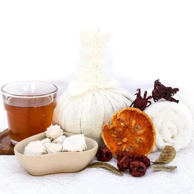 Cloth herbal compress balls, tea glass, dried orange and hibiscus