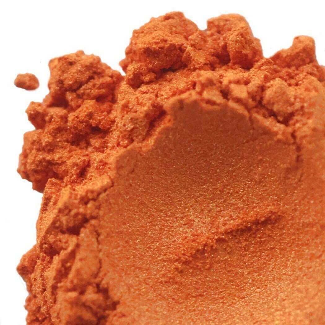 Close-up of vibrant orange handmade powder, part of the Nurture collection.