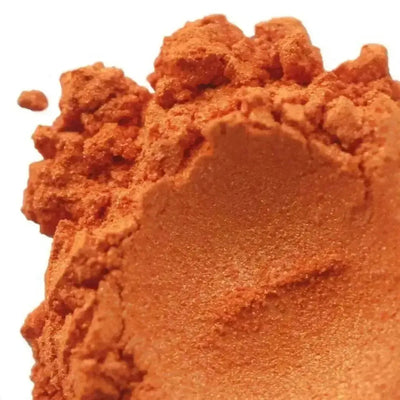 Mound of vivid orange mica powder with pearly shimmer