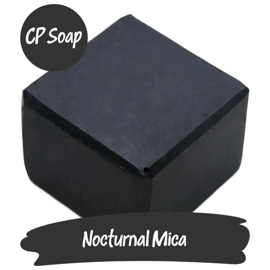 Nocturnal Black Mica soap cube showcasing its deep black color for dramatic cosmetic and artistic uses.
