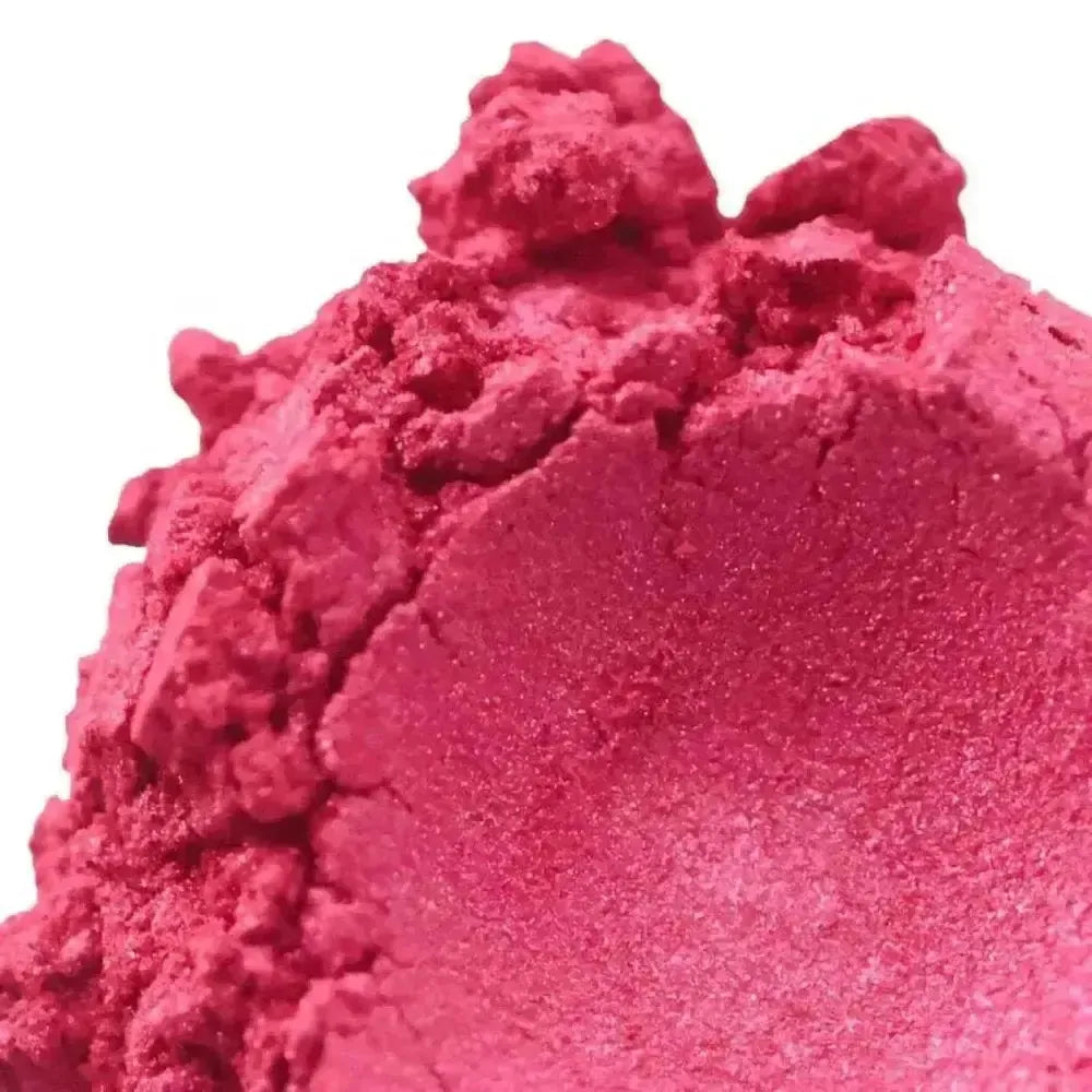 A close-up of Pink Vibrance Mica reveals its fine, crumbly texture and vibrant pink color, making it perfect for craft projects.