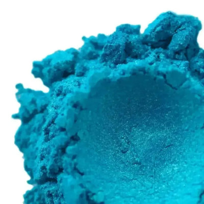 Mound of bright turquoise mica powder with fine shimmer