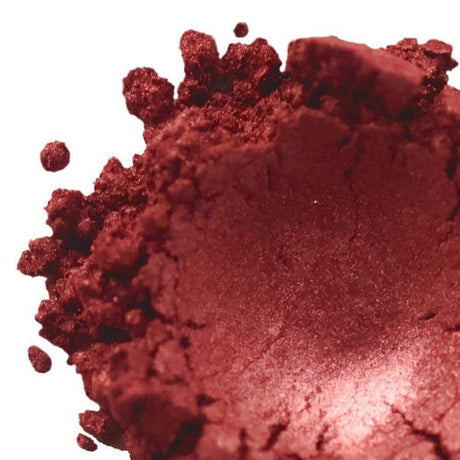 Crushed red mineral powder showcasing Nurture Handmade makeup products.