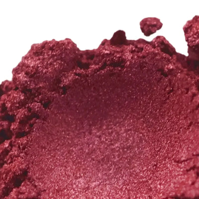 Mound of deep crimson red mica powder with metallic shimmer