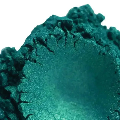 Mound of deep teal green mica powder with shimmer