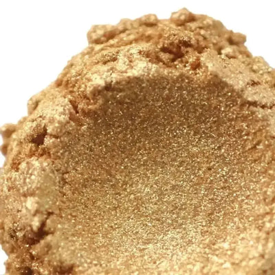 Heaped shimmering warm gold mica powder with fine sparkle
