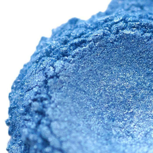 Close-up of shimmering blue handmade eyeshadow powder texture from Nurture Handmade