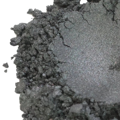 Mound of dark charcoal grey mica powder with silver sparkle
