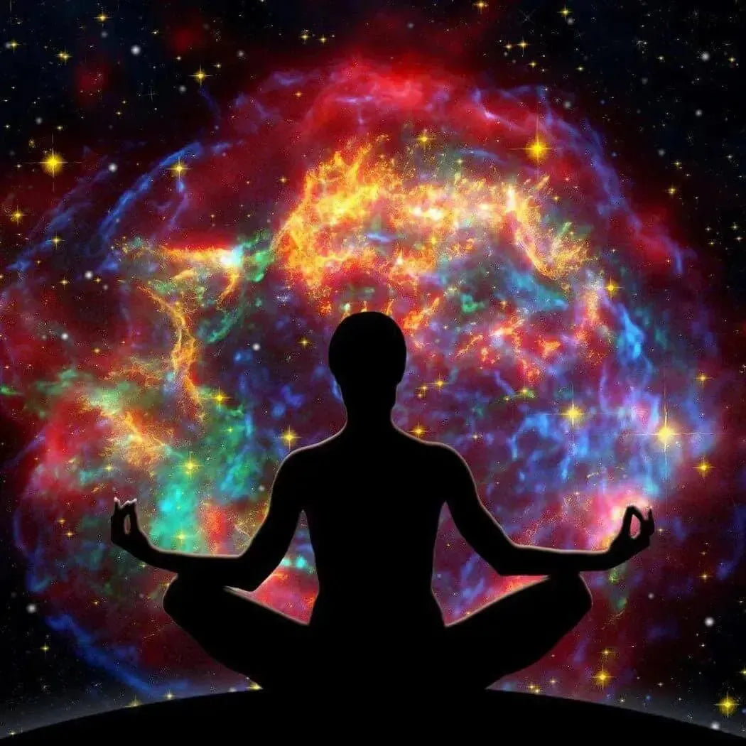 Silhouette of yogi in lotus pose against cosmic nebula for Star Showers Fragrance Blend