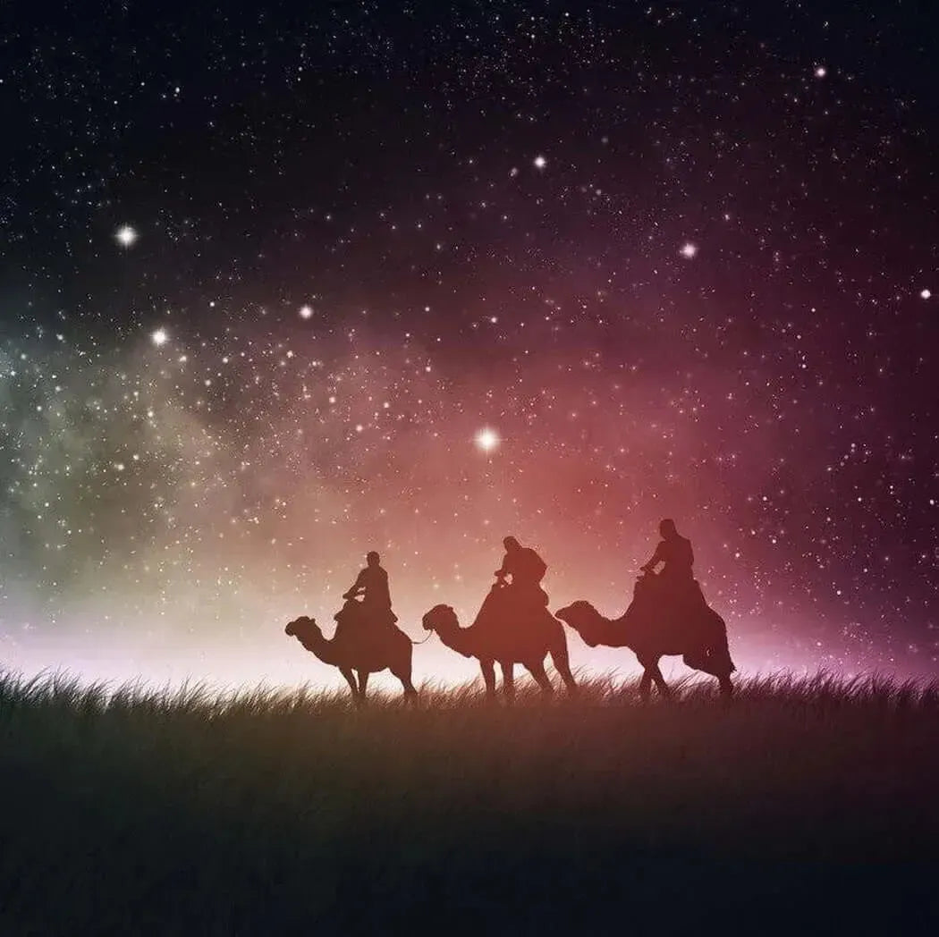 Silhouette of Three Wise Men riding camels under a starry night sky, symbolizing their journey and gifts.