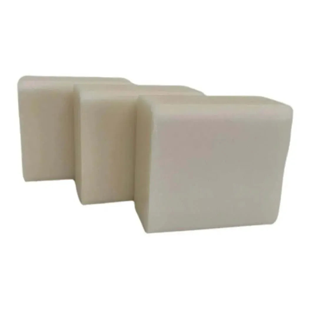 Three off-white rectangular Low Sweat White Soap Base bars with smooth rounded edges