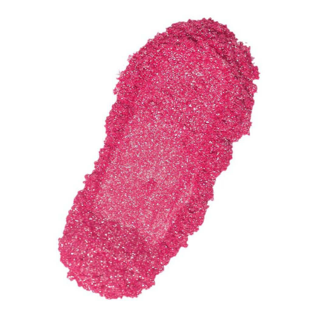 Close-up of pink glitter lipstick smear showing texture. Nurture Handmade beauty product.