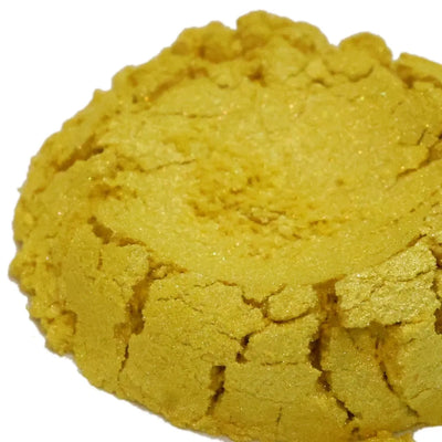 Mound of golden yellow mica powder with pearly shimmer